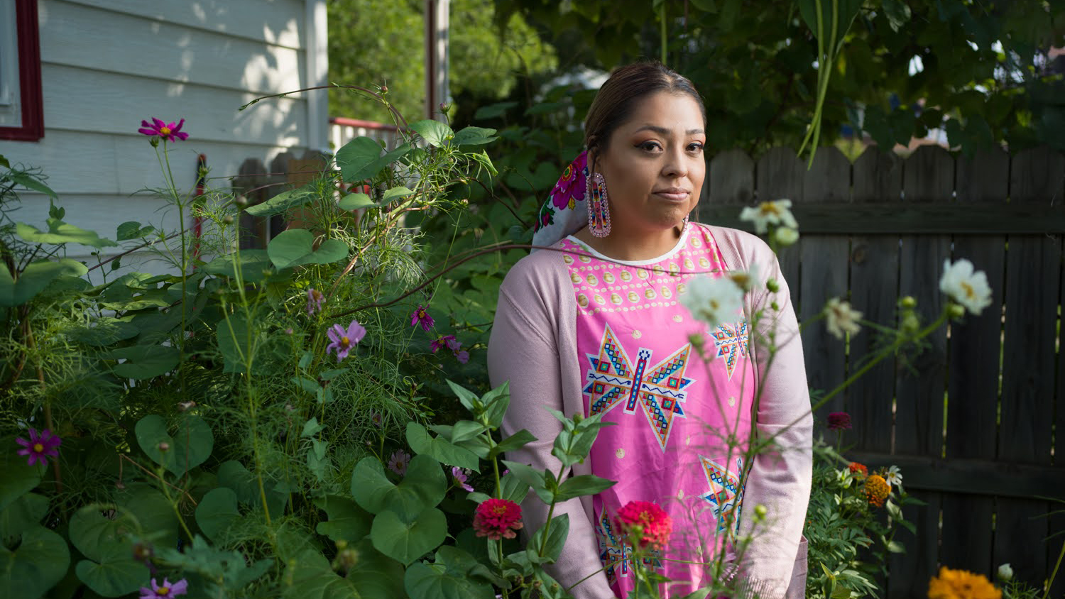 “Native Way Forward” roadtripper Kimberlee—from the Fort Berthold Reservation in North Dakota—poses in the garden outside her home.